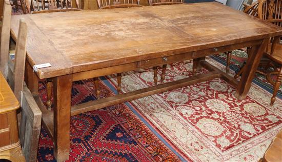 A 19th century French farmhouse extending kitchen dining table, fitted two mid drawers, with one spare leaf 270cm extended